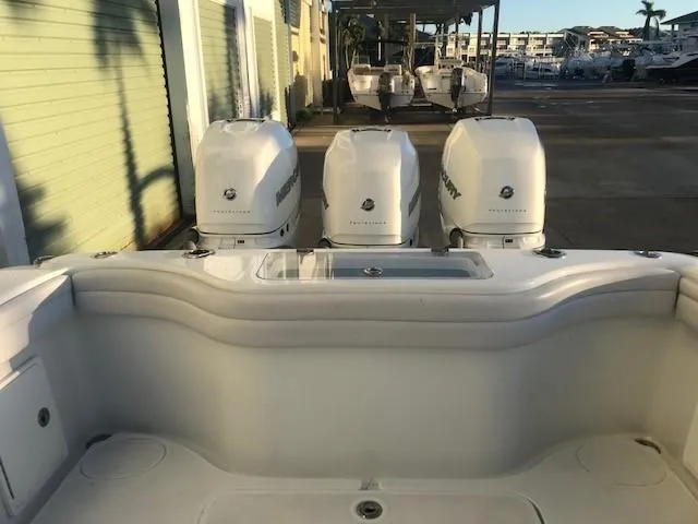  Yacht Photos Pics 2019 Yellowfin 34 Offshore boat with triple Mercury engines at a marina.