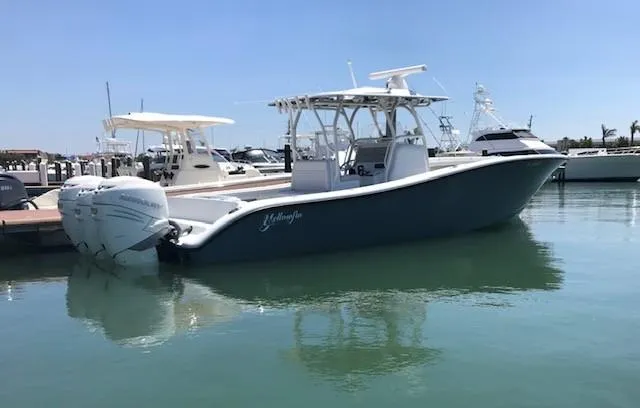  Yacht Photos Pics 2019 Yellowfin 34 Offshore boat docked in marina, calm water, clear sky.