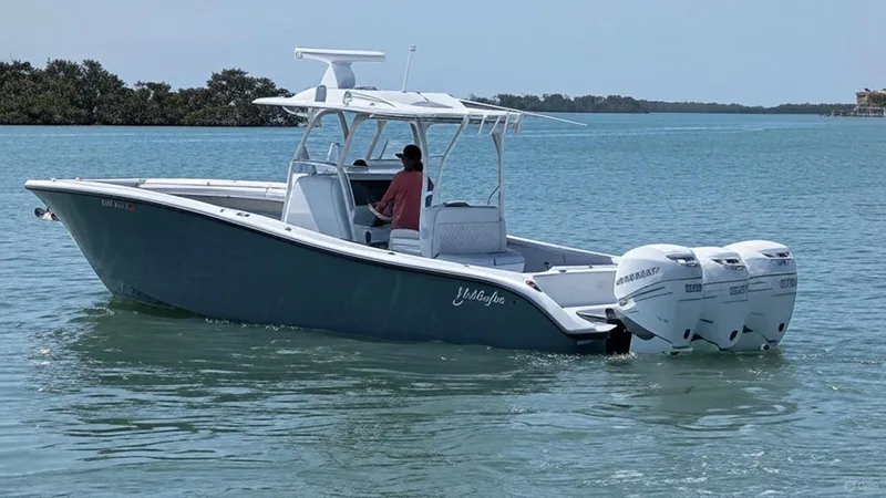  Yacht Photos Pics 2019 Yellowfin 34 Offshore boat cruising on calm waters with dual outboard engines.