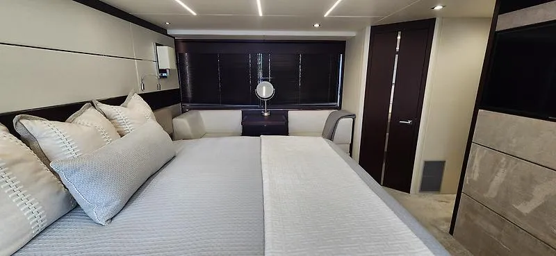  Yacht Photos Pics Luxurious bedroom interior of 2020 Sunseeker Predator 74 XPS yacht, featuring elegant bedding and modern design.