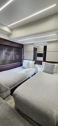  Yacht Photos Pics Luxurious twin bedroom in 2020 Sunseeker Predator 74 XPS yacht, featuring modern design and ambient lighting.