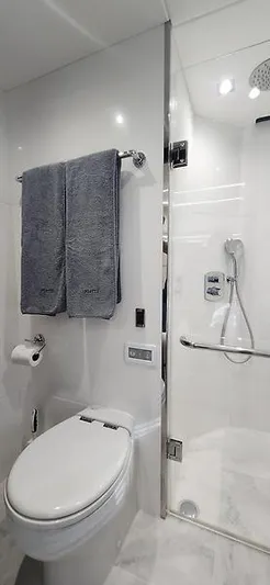  Yacht Photos Pics Luxurious bathroom in 2020 Sunseeker Predator 74 XPS yacht, featuring modern shower and toilet.