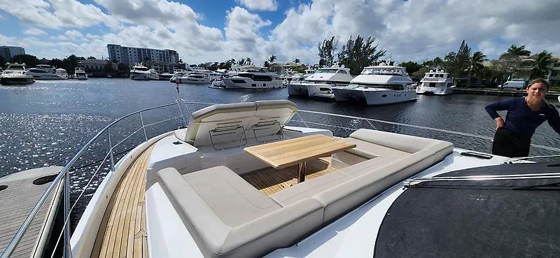  Yacht Photos Pics Sunseeker Predator 74 XPS yacht, 2020 model, docked with luxurious seating and table on deck.