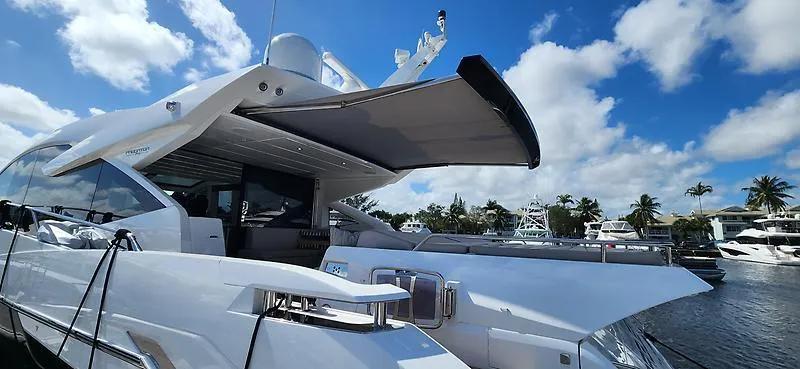  Yacht Photos Pics Luxury Sunseeker Predator 74 XPS yacht, 2020 model, docked under a clear blue sky.