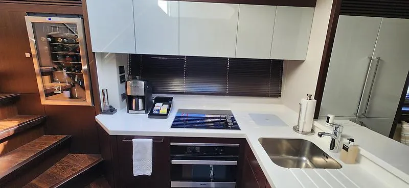  Yacht Photos Pics Modern kitchen in 2020 Sunseeker Predator 74 XPS yacht with sleek appliances and wine cooler.