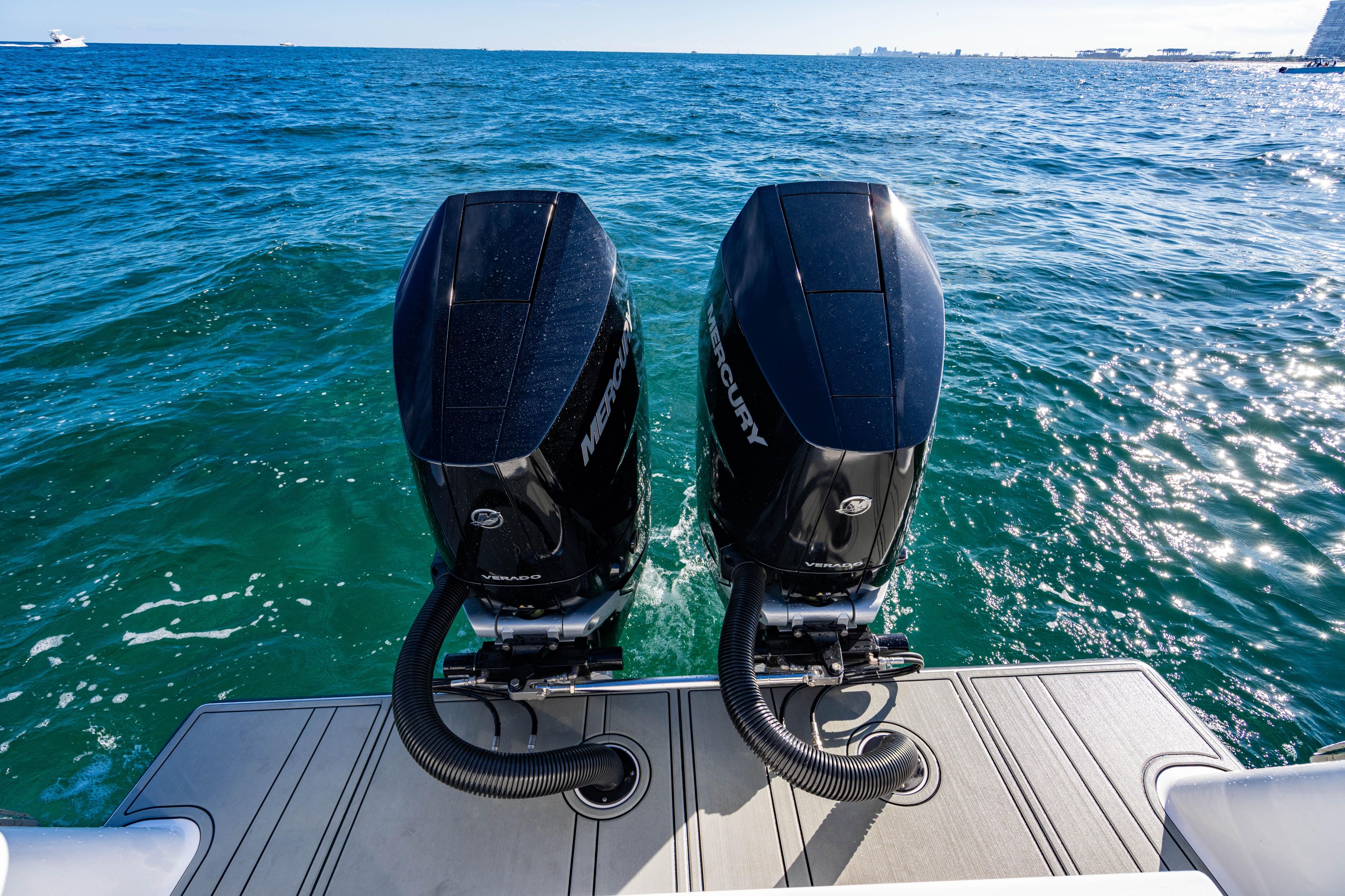 Twin Mercury outboard engines on a 2026 Reef Runner 340 boat, cruising on open water.