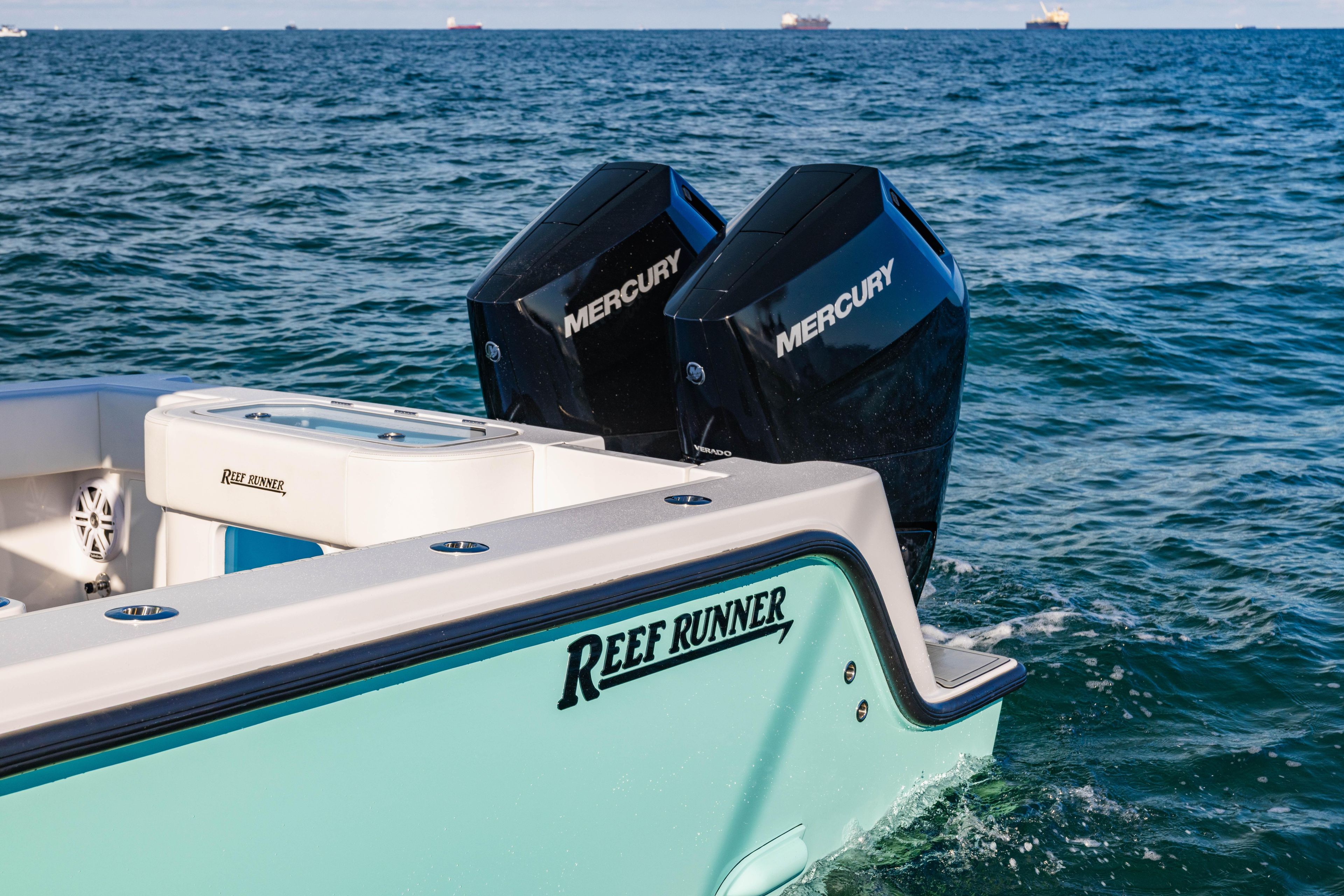 2026 Reef Runner 340 boat with dual Mercury engines on open water.