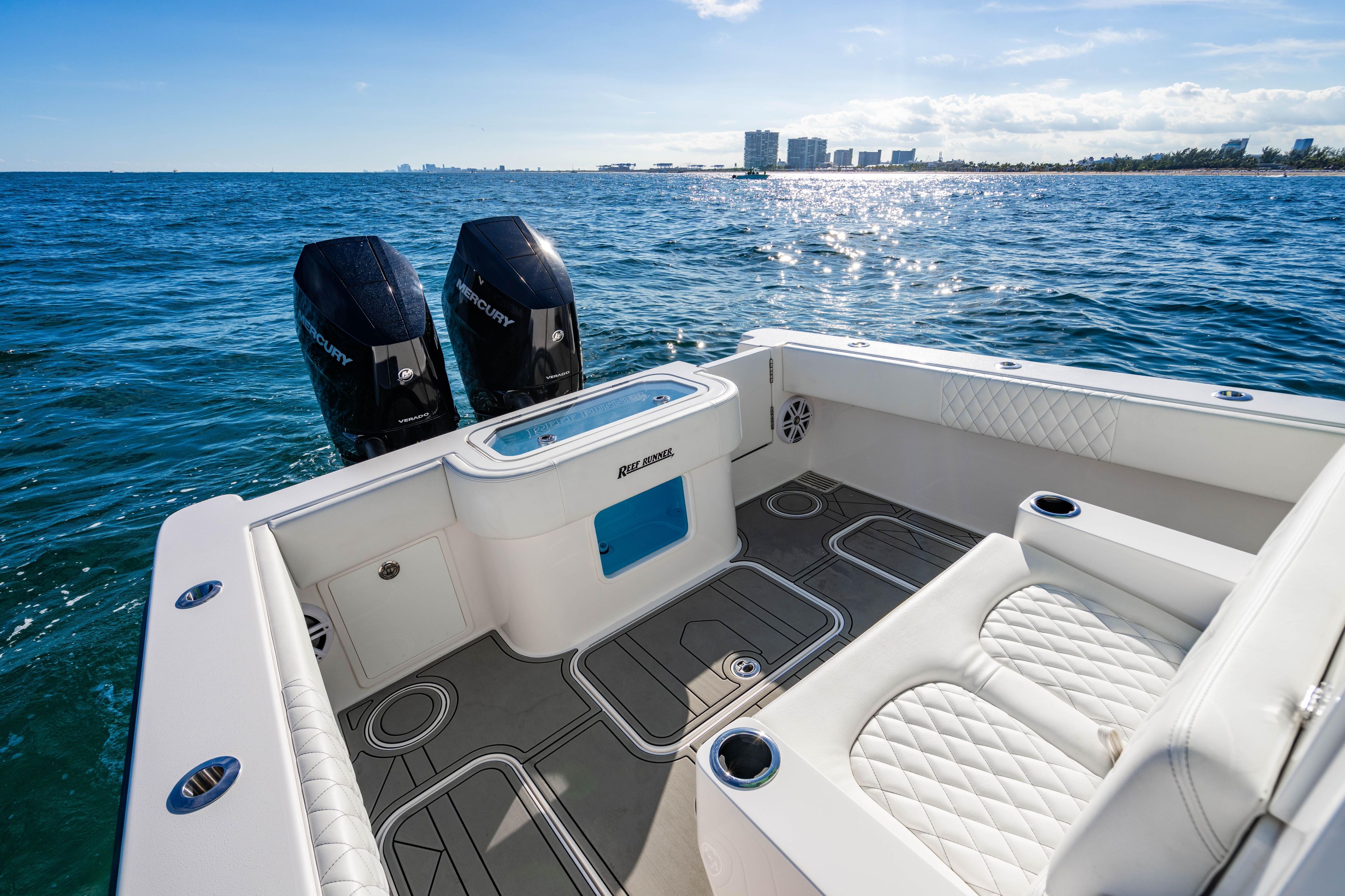 Luxury 2026 Reef Runner 340 boat with dual Mercury engines on open sea.