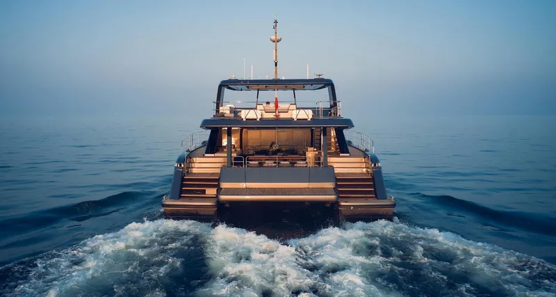  Yacht Photos Pics 2026 Sunreef 60 Power yacht cruising on calm ocean waters.