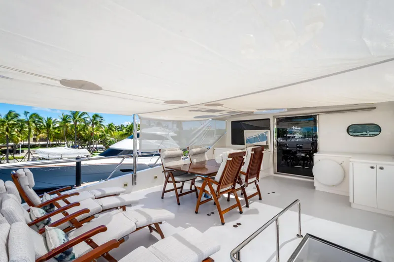 Lucky Penny Yacht Photos Pics Luxurious 2014 Hargrave Sky Lounge yacht deck with seating, dining area, and canopy.