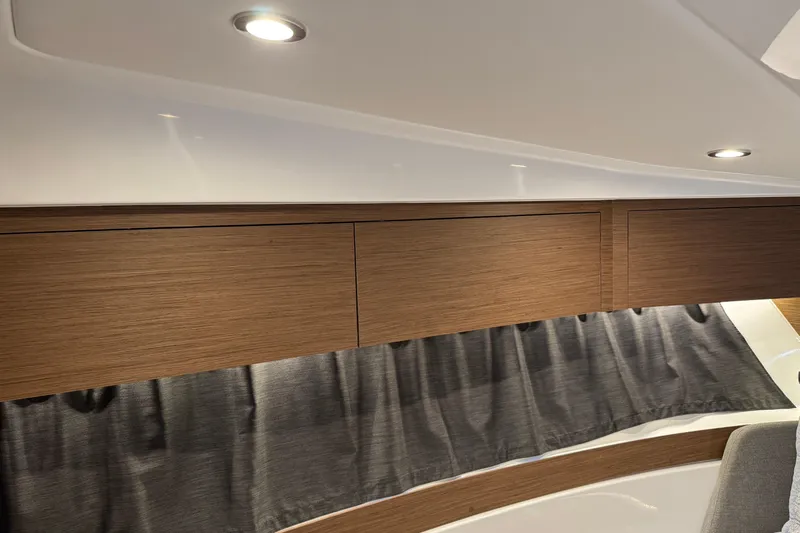  Yacht Photos Pics 2024 Beneteau Antares 11 interior with wooden cabinets and modern lighting.