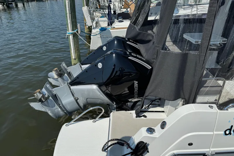  Yacht Photos Pics 2024 Beneteau Antares 11 with dual Mercury outboard engines docked at marina.