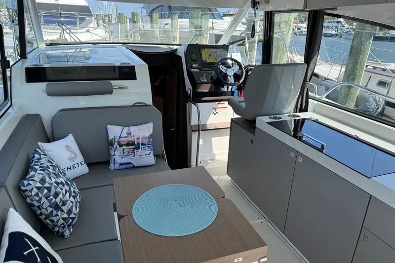  Yacht Photos Pics Interior of 2024 Beneteau Antares 11, featuring modern seating and navigation area.