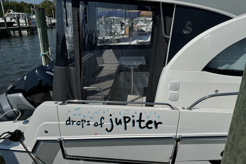  Yacht Photos Pics 2024 Beneteau Antares 11 boat docked, featuring "drops of jupiter" text on the stern.