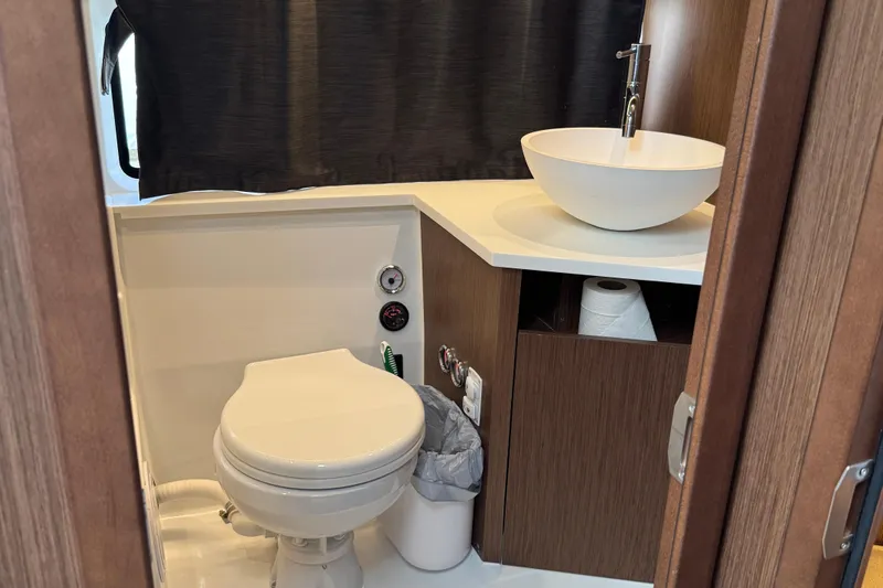  Yacht Photos Pics 2024 Beneteau Antares 11 bathroom with modern sink and toilet.