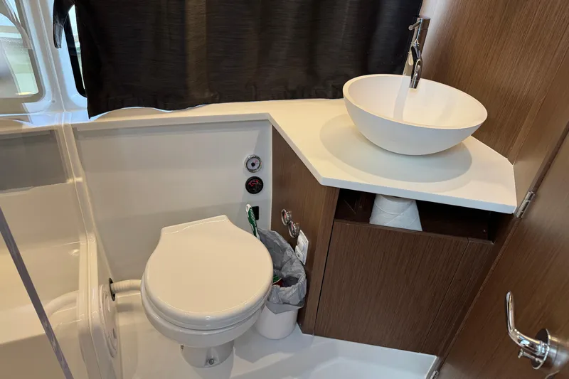  Yacht Photos Pics 2024 Beneteau Antares 11 bathroom with modern sink and toilet.