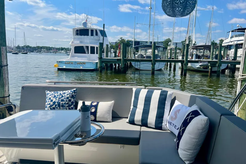  Yacht Photos Pics 2024 Beneteau Antares 11 yacht interior with stylish seating and marina view.