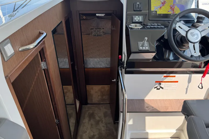  Yacht Photos Pics Interior view of 2024 Beneteau Antares 11 boat cockpit and cabin entrance.