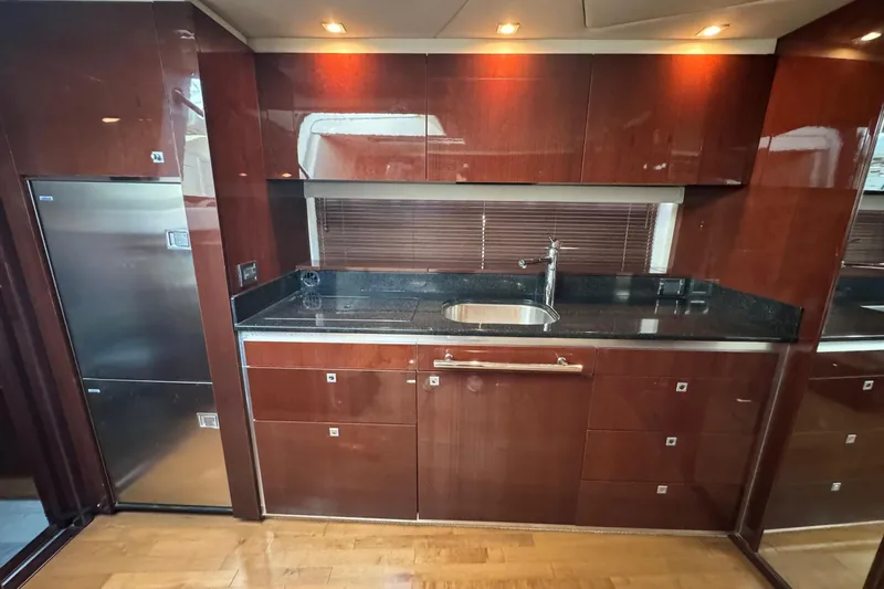 Land Escape Yacht Photos Pics Luxurious kitchen interior of 2010 Sea Ray 470 Sundancer yacht with sleek cabinetry.