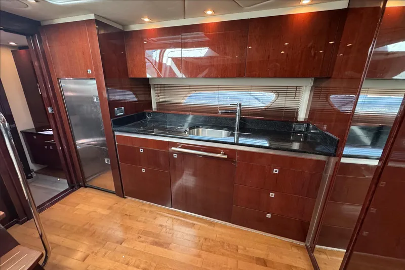 Land Escape Yacht Photos Pics Luxurious kitchen interior of 2010 Sea Ray 470 Sundancer yacht with wood cabinetry and modern appliances.