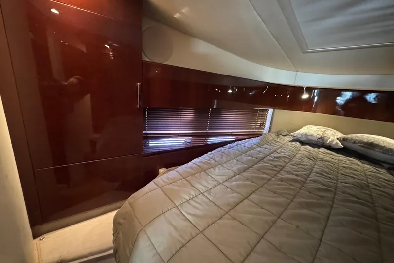 Land Escape Yacht Photos Pics Luxurious cabin interior of 2010 Sea Ray 470 Sundancer yacht with cozy bedding.