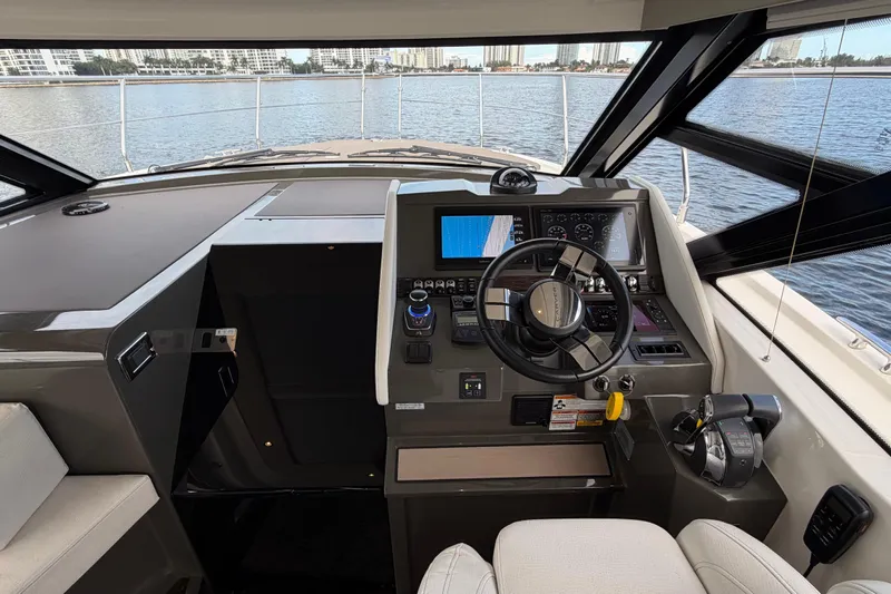 Mj Yacht Photos Pics 2019 Carver C34 yacht helm with modern controls and navigation system, overlooking serene waters.