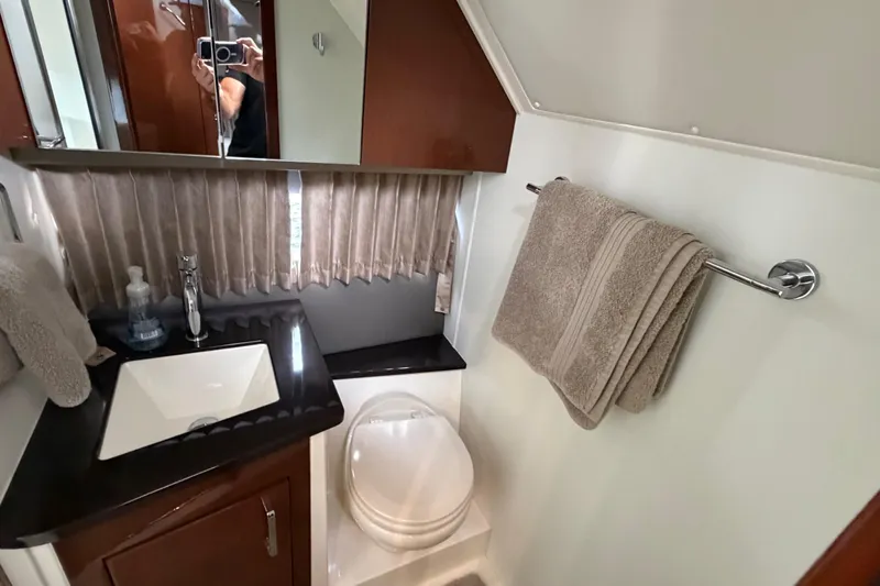 Mj Yacht Photos Pics 2019 Carver C34 yacht bathroom with sink, toilet, and towel rack.
