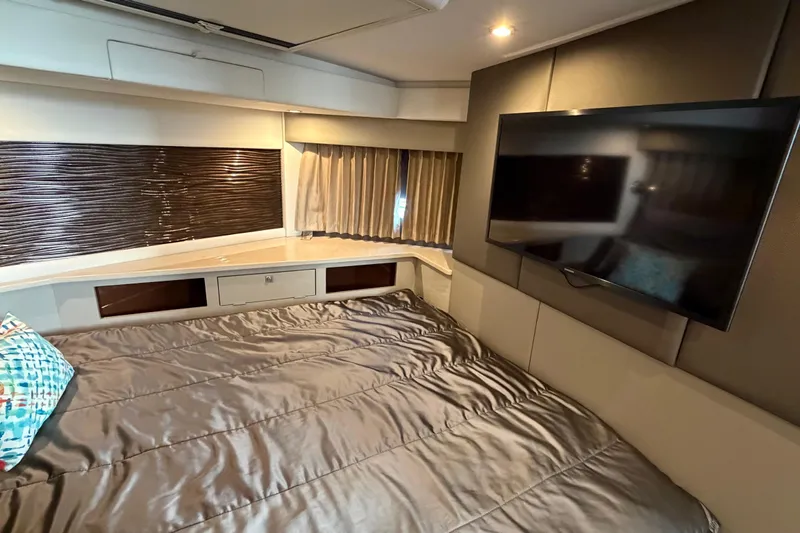 Mj Yacht Photos Pics Luxurious 2019 Carver C34 yacht bedroom with TV, modern decor, and comfortable bedding.