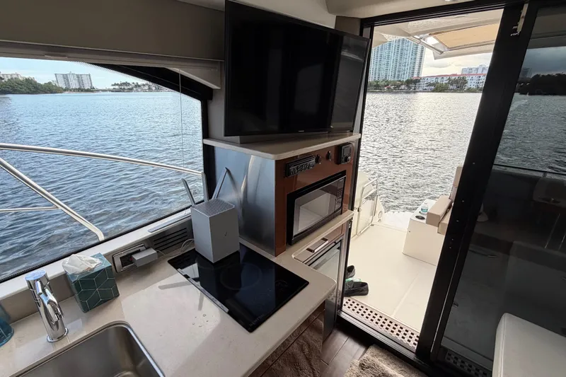 Mj Yacht Photos Pics Interior of 2019 Carver C34 yacht with kitchen, TV, and water view.