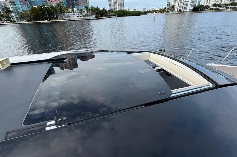 Mj Yacht Photos Pics 2019 Carver C34 yacht with sunroof, docked by waterfront cityscape.