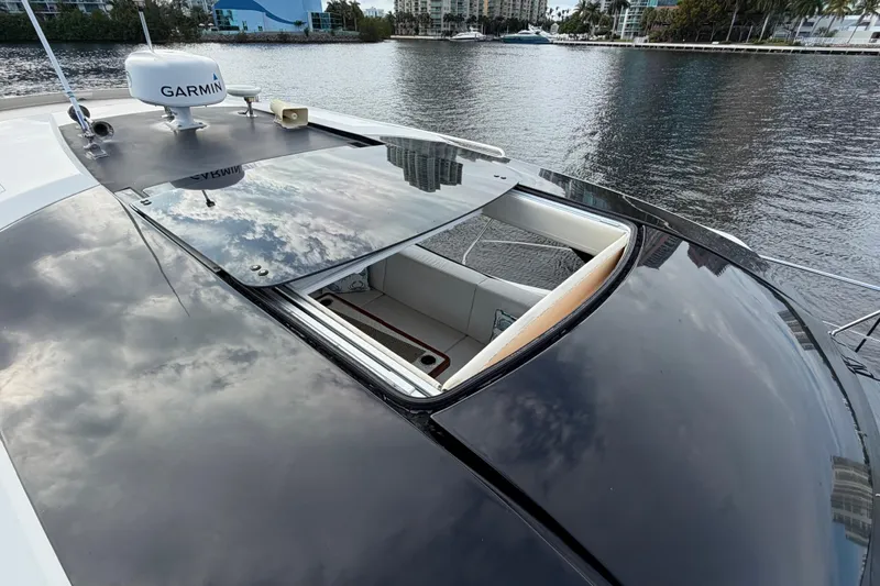 Mj Yacht Photos Pics 2019 Carver C34 yacht with open sunroof, reflecting cloudy sky on water.