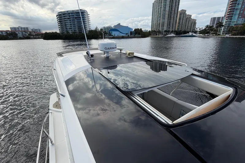 Mj Yacht Photos Pics 2019 Carver C34 yacht on water, city skyline in background, overcast sky.