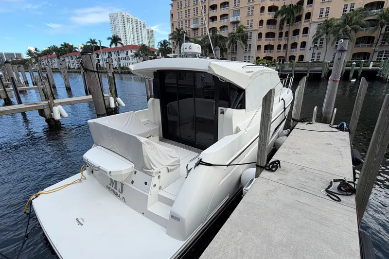 Mj Yacht Photos Pics 2019 Carver C34 yacht docked at marina with waterfront buildings.