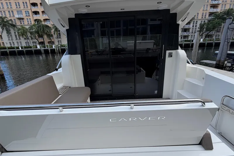 Mj Yacht Photos Pics 2019 Carver C34 yacht with sleek design, docked near waterfront buildings.
