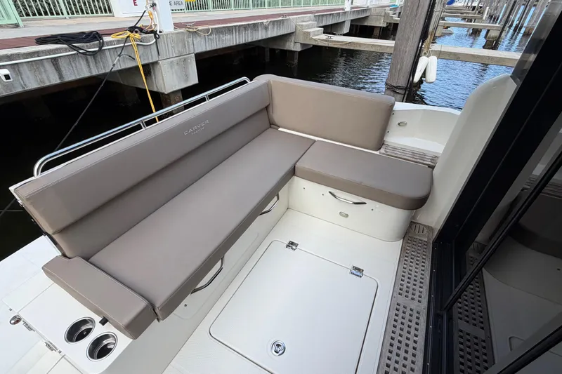 Mj Yacht Photos Pics 2019 Carver C34 yacht seating area with beige cushions at a marina dock.
