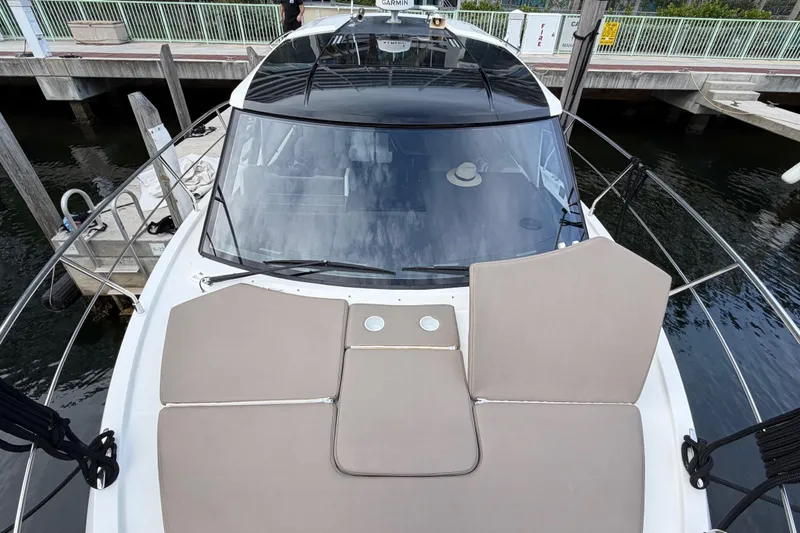 Mj Yacht Photos Pics 2019 Carver C34 yacht with beige sunbathing cushions docked at marina.