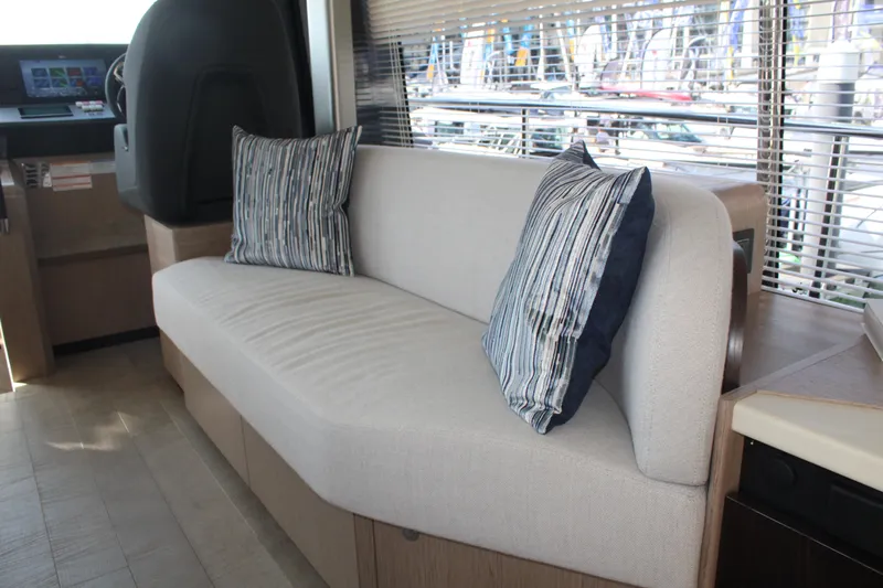 In Stock Yacht Photos Pics Luxurious interior of 2025 Absolute 47 Fly yacht with comfortable seating and striped cushions.