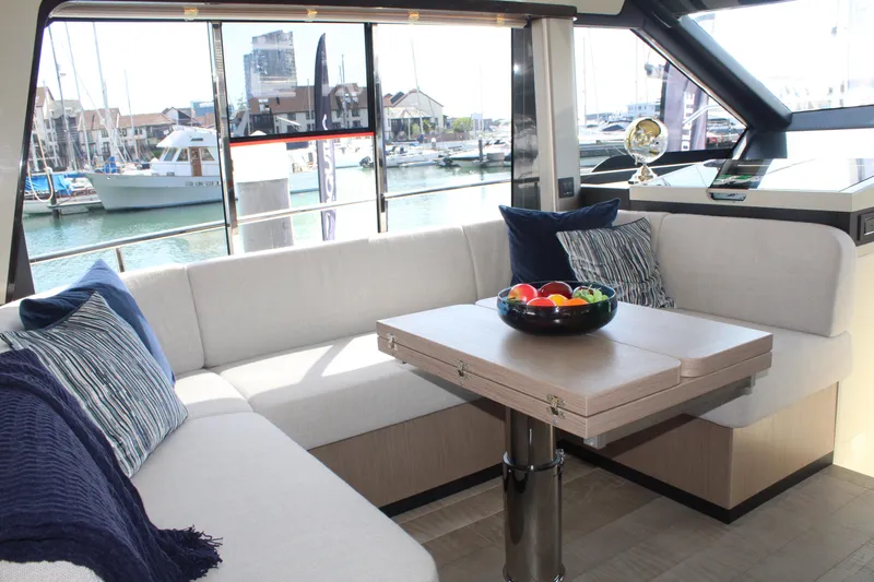 In Stock Yacht Photos Pics Luxurious interior of 2025 Absolute 47 Fly yacht with marina view.