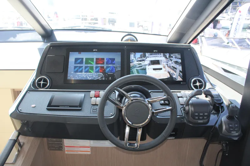 In Stock Yacht Photos Pics Helm of 2025 Absolute 47 Fly yacht with advanced navigation displays and controls.