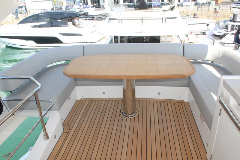 In Stock Yacht Photos Pics 2025 Absolute 47 Fly yacht with teak deck and elegant outdoor seating area.