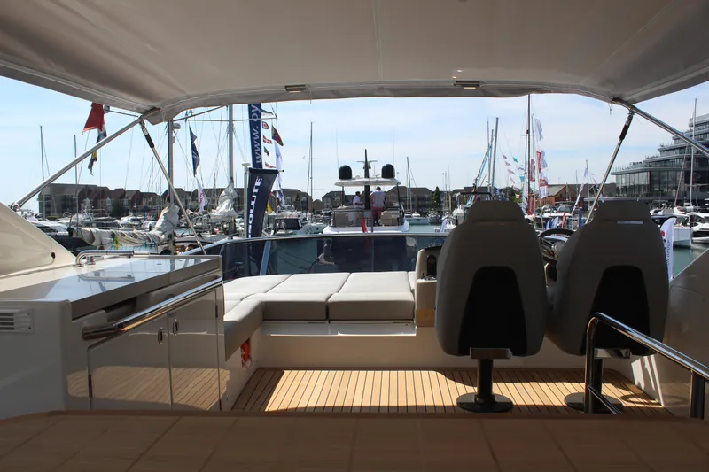 In Stock Yacht Photos Pics Luxury Absolute 47 Fly yacht interior, 2025 model, featuring sleek seating and marina view.