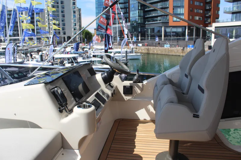 In Stock Yacht Photos Pics Flybridge of 2025 Absolute 47 Fly yacht with modern controls and seating.