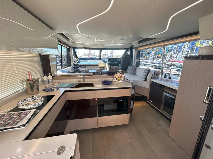 In Stock Yacht Photos Pics Luxurious interior of 2025 Absolute 47 Fly yacht with modern kitchen and seating area.