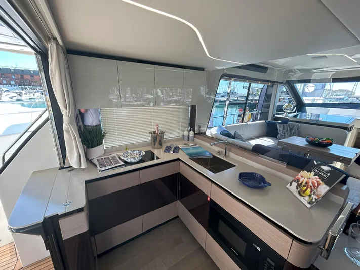 In Stock Yacht Photos Pics Modern kitchen interior of 2025 Absolute 47 Fly yacht with sleek design and marina view.