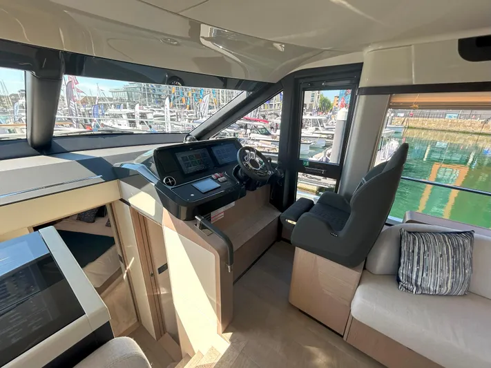 In Stock Yacht Photos Pics Interior of 2025 Absolute 47 Fly yacht with modern helm and seating area.