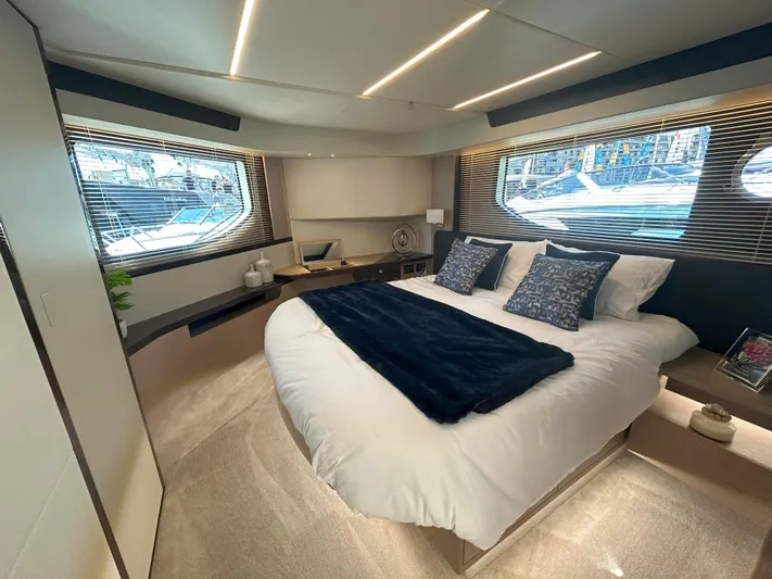 In Stock Yacht Photos Pics Luxurious bedroom interior of 2025 Absolute 47 Fly yacht with modern design and large windows.