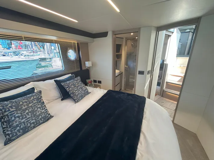 In Stock Yacht Photos Pics Luxurious bedroom interior of 2025 Absolute 47 Fly yacht with modern decor and large window.
