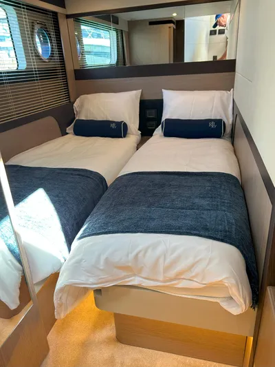 In Stock Yacht Photos Pics 2025 Absolute 47 Fly yacht cabin with twin beds, blue accents, and modern decor.