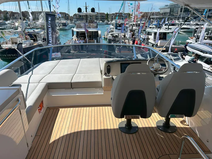 In Stock Yacht Photos Pics Flybridge view of 2025 Absolute 47 Fly yacht at a bustling marina.
