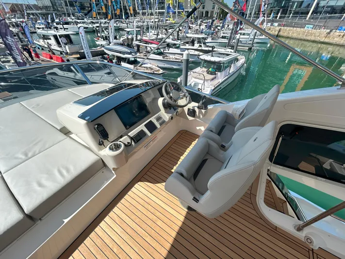 In Stock Yacht Photos Pics Flybridge of 2025 Absolute 47 Fly yacht with modern controls and seating.